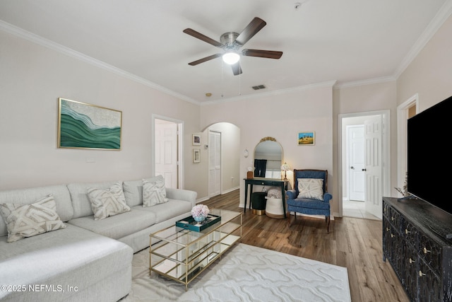 living room with crown molding, hardwood / wood-style flooring, and ceiling fan