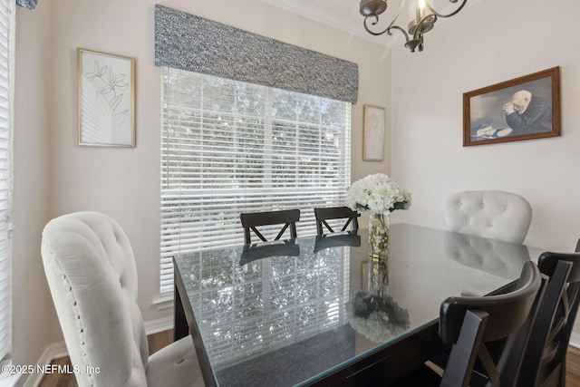 dining room with crown molding and a chandelier