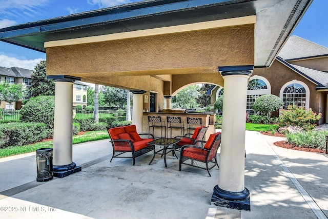 view of patio featuring an outdoor bar