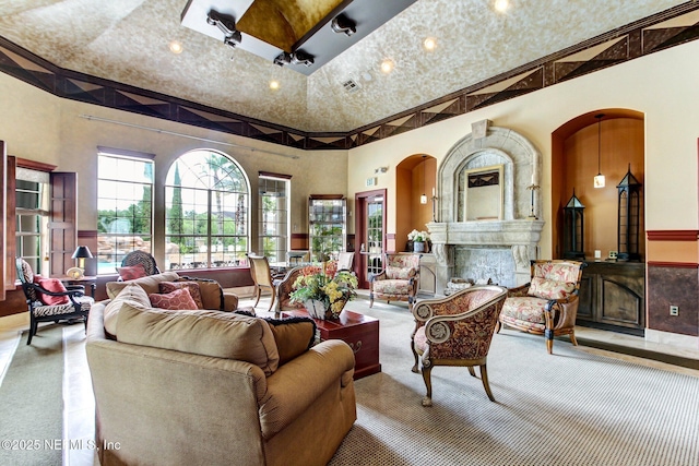 living room featuring a towering ceiling and a fireplace