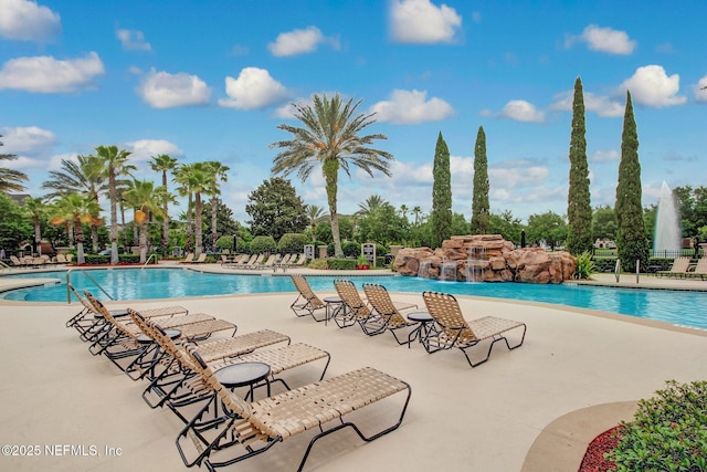 view of pool featuring pool water feature and a patio area