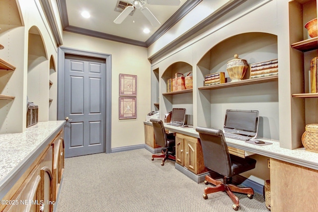 office area with crown molding, ceiling fan, built in desk, and light carpet