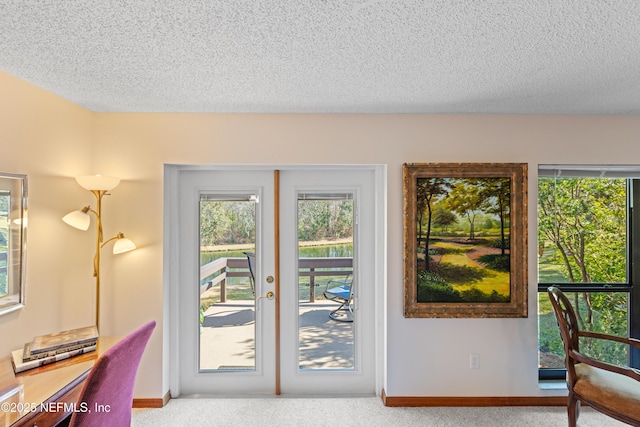 doorway featuring carpet floors, french doors, and a textured ceiling