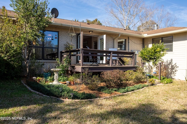 back of property featuring a yard and a deck