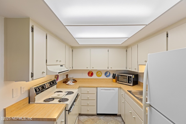 kitchen featuring white appliances and white cabinets