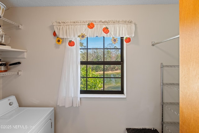 washroom with washer / dryer and a textured ceiling