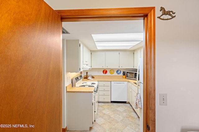 kitchen with white cabinets and white appliances