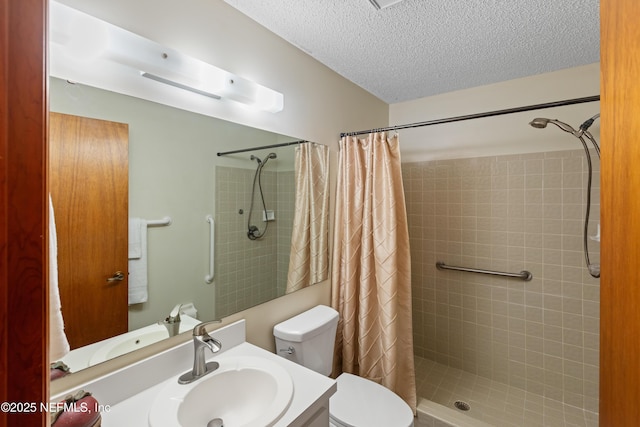 bathroom with vanity, toilet, a textured ceiling, and a shower with curtain