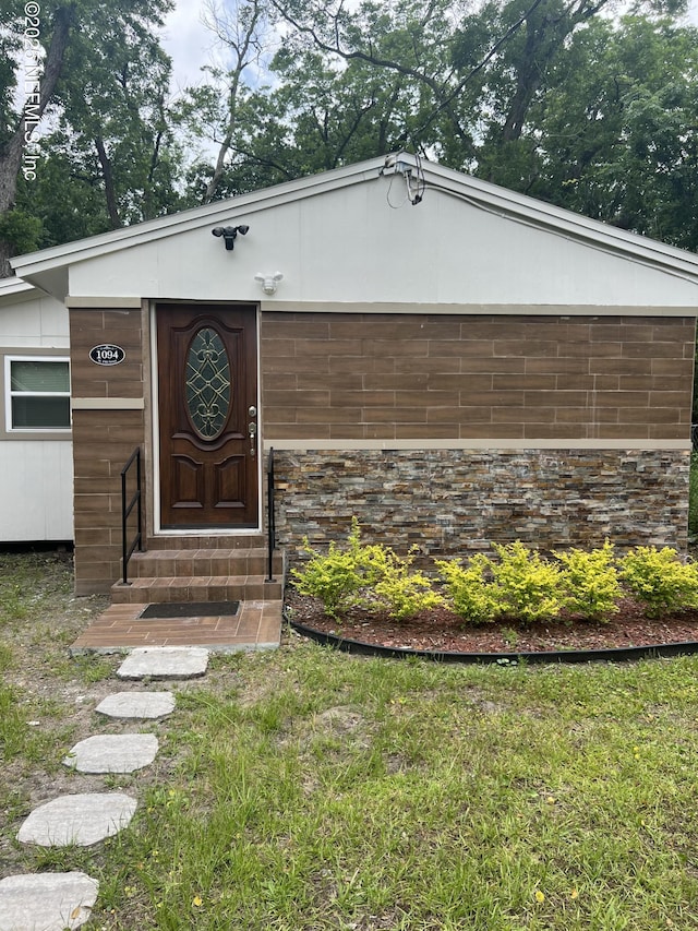 entrance to property featuring stone siding