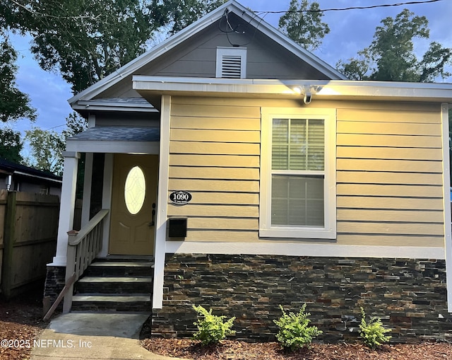 view of exterior entry with fence