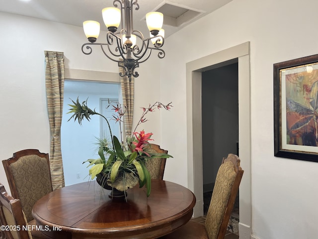 dining area with an inviting chandelier