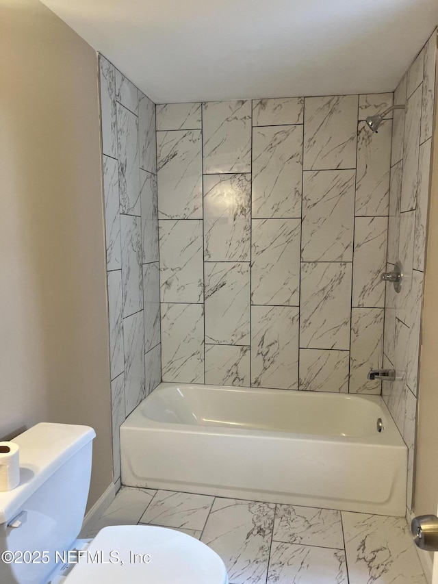 full bathroom with marble finish floor, shower / washtub combination, and toilet