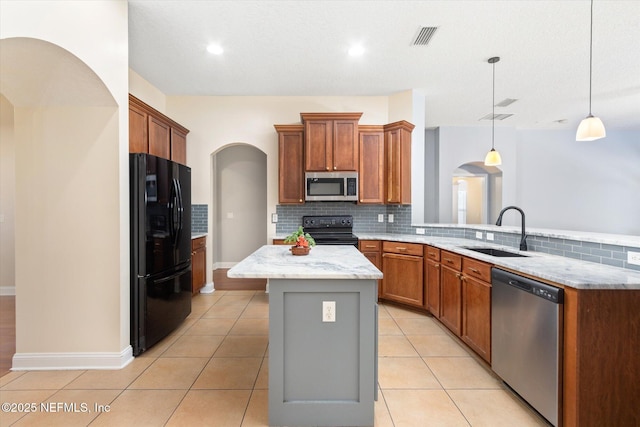 kitchen featuring decorative light fixtures, sink, a center island, light tile patterned floors, and black appliances