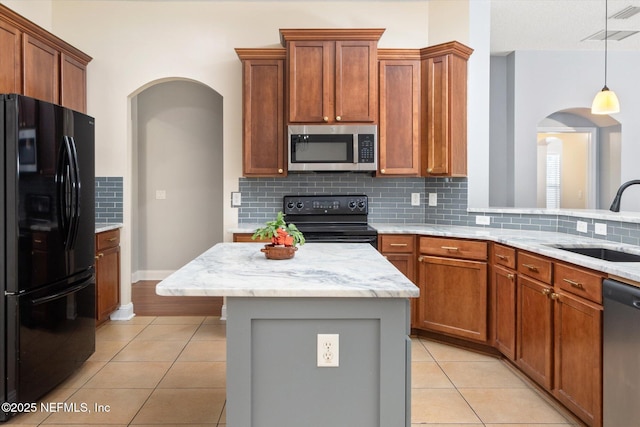 kitchen with light tile patterned flooring, sink, a center island, pendant lighting, and black appliances