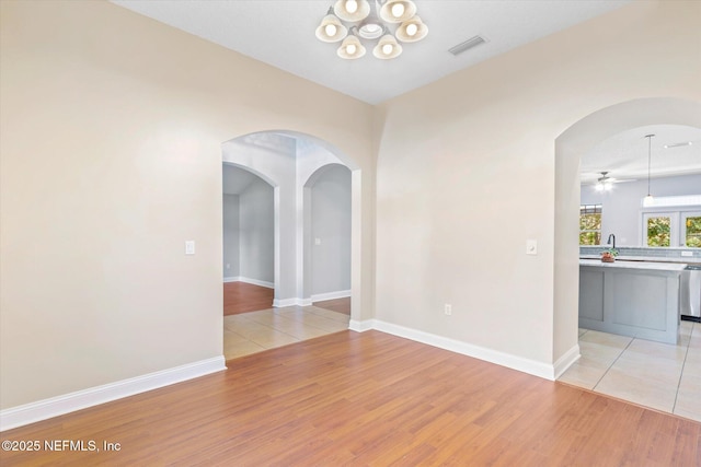 unfurnished room featuring ceiling fan and light wood-type flooring