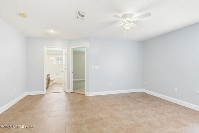 unfurnished room featuring a textured ceiling, ceiling fan, and light tile patterned flooring