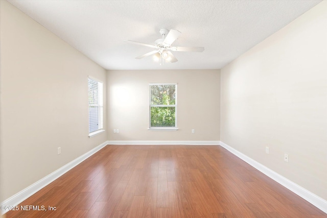 unfurnished room featuring hardwood / wood-style floors, a textured ceiling, and ceiling fan