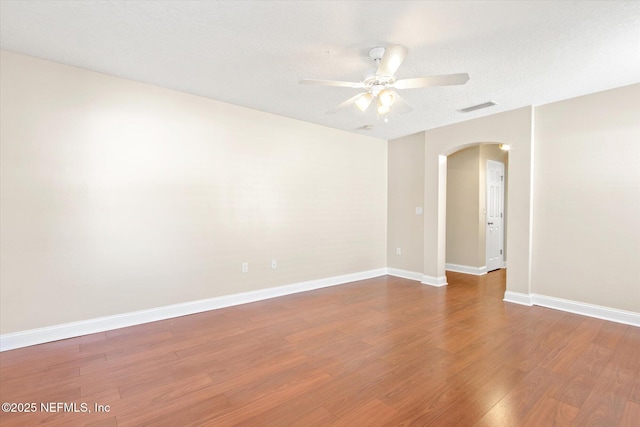 spare room with wood-type flooring and ceiling fan