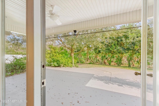 doorway to outside with a wealth of natural light and ceiling fan