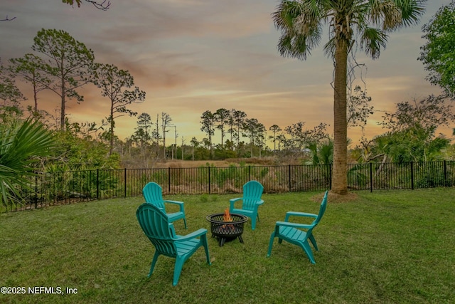 playground at dusk with a yard and a fire pit