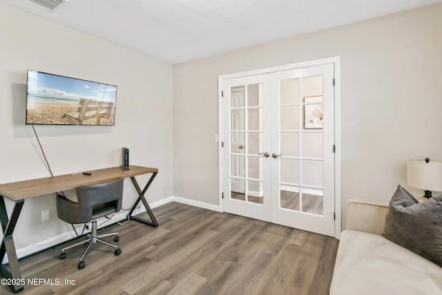 home office featuring hardwood / wood-style floors and french doors