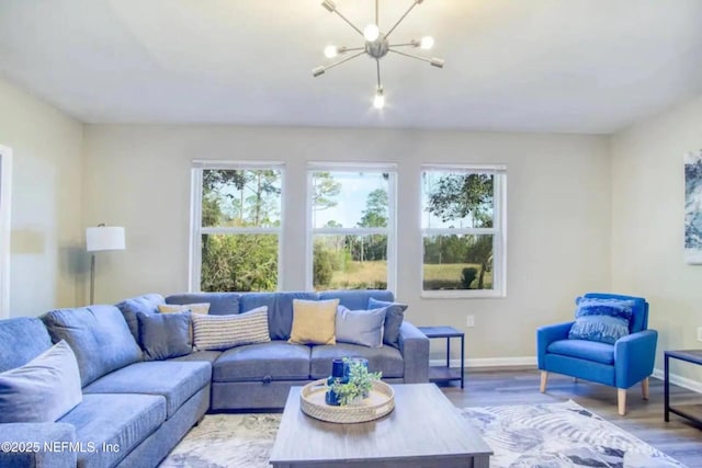 living room featuring a chandelier, hardwood / wood-style floors, and a wealth of natural light