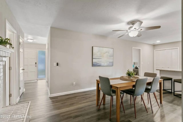 dining area featuring ceiling fan, dark hardwood / wood-style floors, and a textured ceiling