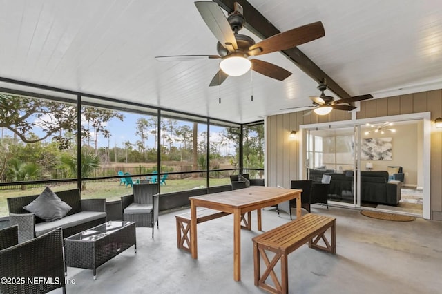 sunroom featuring beamed ceiling