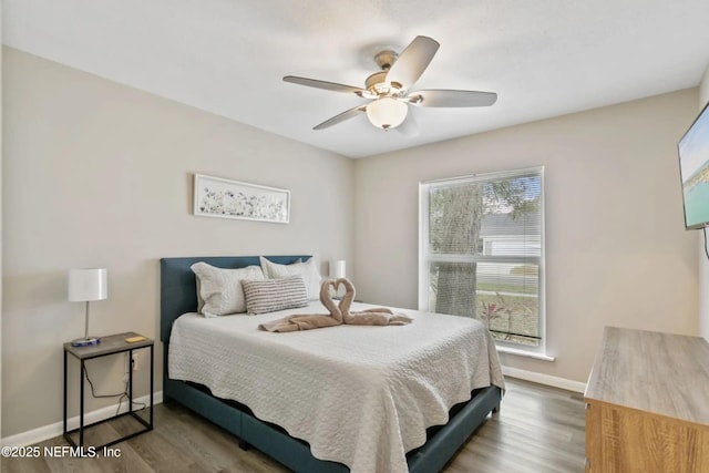 bedroom featuring hardwood / wood-style flooring and ceiling fan