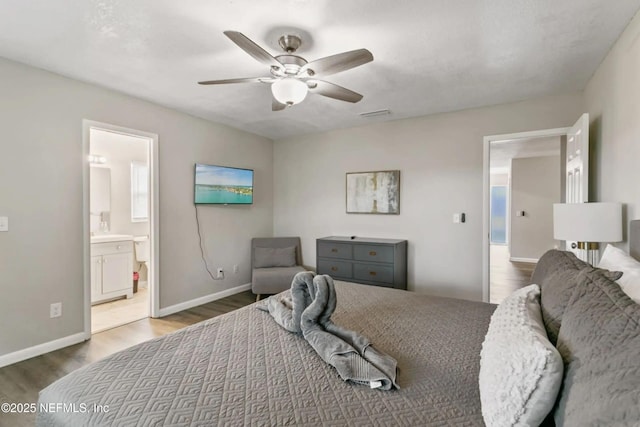 bedroom featuring connected bathroom, hardwood / wood-style floors, and ceiling fan