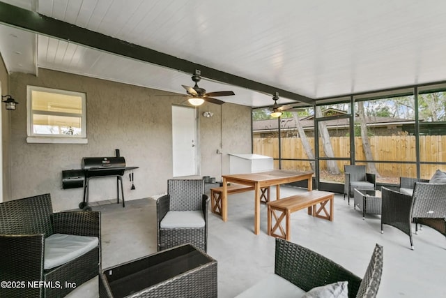 living room featuring ceiling fan and beam ceiling