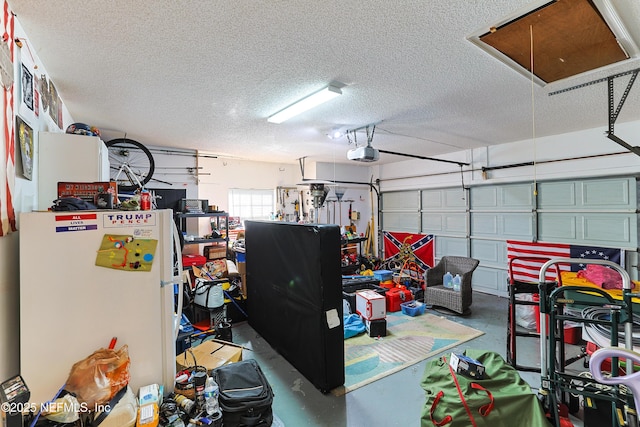 garage featuring a garage door opener and white fridge