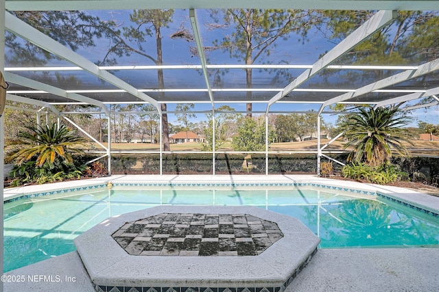 view of swimming pool with glass enclosure