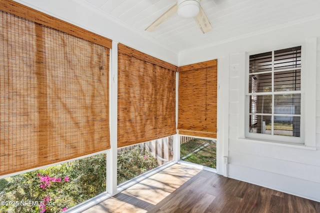 unfurnished sunroom with a ceiling fan