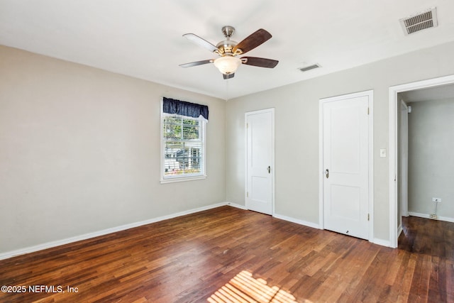 unfurnished bedroom featuring wood finished floors, visible vents, and baseboards