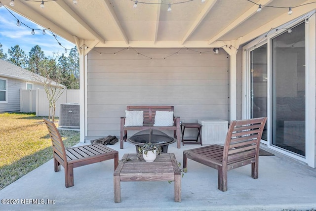 view of patio with central AC and an outdoor fire pit