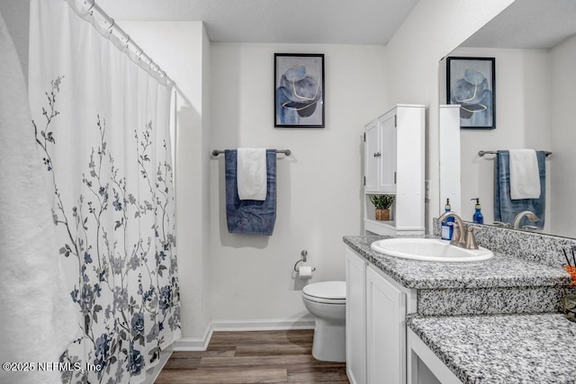 bathroom featuring vanity, wood-type flooring, toilet, and a shower with shower curtain