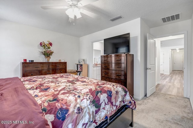 carpeted bedroom featuring ceiling fan and connected bathroom