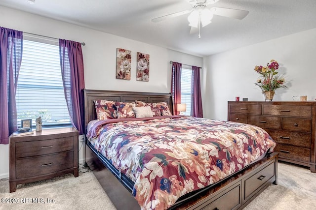 bedroom featuring light colored carpet and ceiling fan