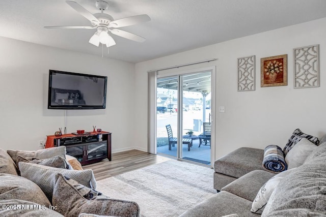 living room featuring light hardwood / wood-style floors and ceiling fan