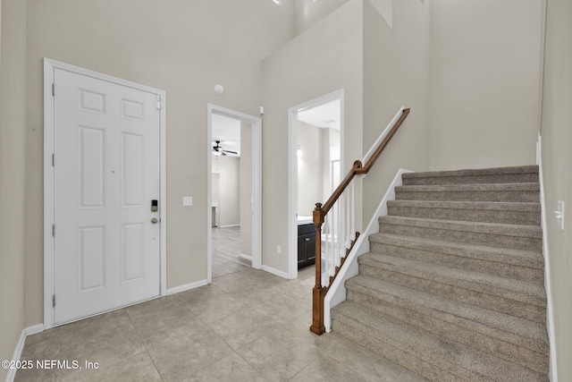 foyer featuring a high ceiling and light tile patterned floors