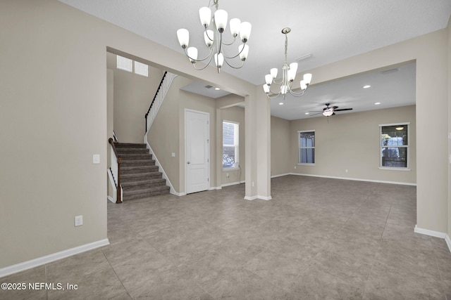 interior space featuring ceiling fan with notable chandelier