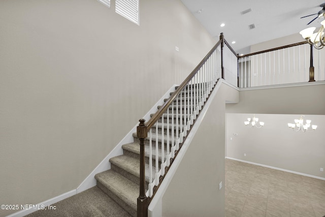 stairway with a notable chandelier and a high ceiling