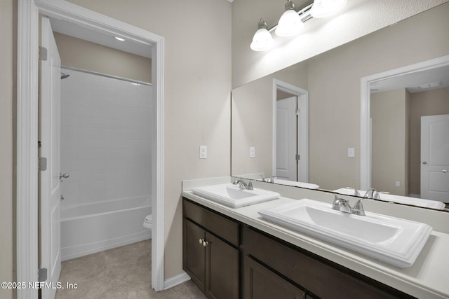 full bathroom featuring vanity, bathing tub / shower combination, and toilet