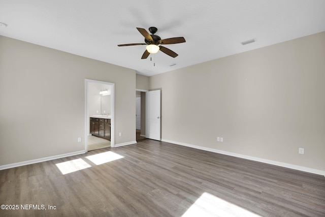 unfurnished bedroom with connected bathroom, light hardwood / wood-style floors, and ceiling fan