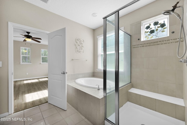 bathroom with separate shower and tub and tile patterned flooring