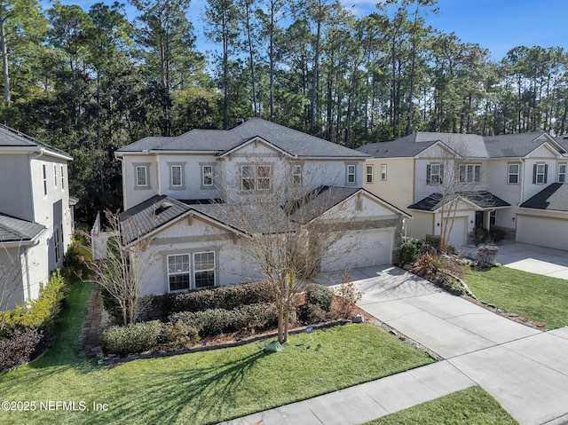 view of front of house with a garage and a front yard