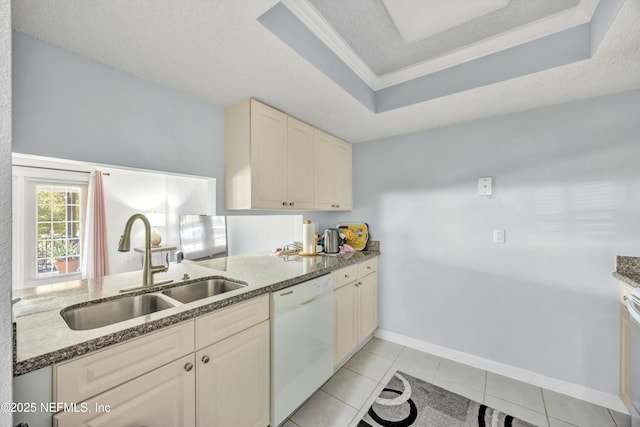 kitchen with sink, a textured ceiling, light tile patterned floors, white dishwasher, and a raised ceiling