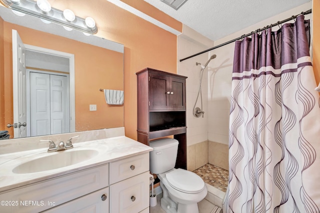 bathroom with a shower with curtain, vanity, toilet, and a textured ceiling