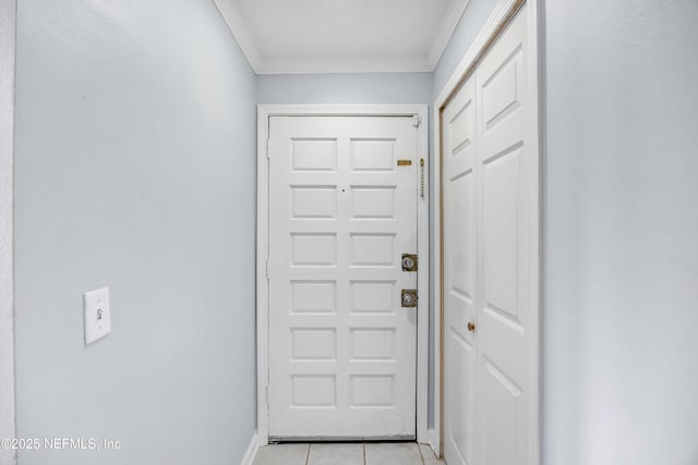 entryway featuring light tile patterned flooring and crown molding